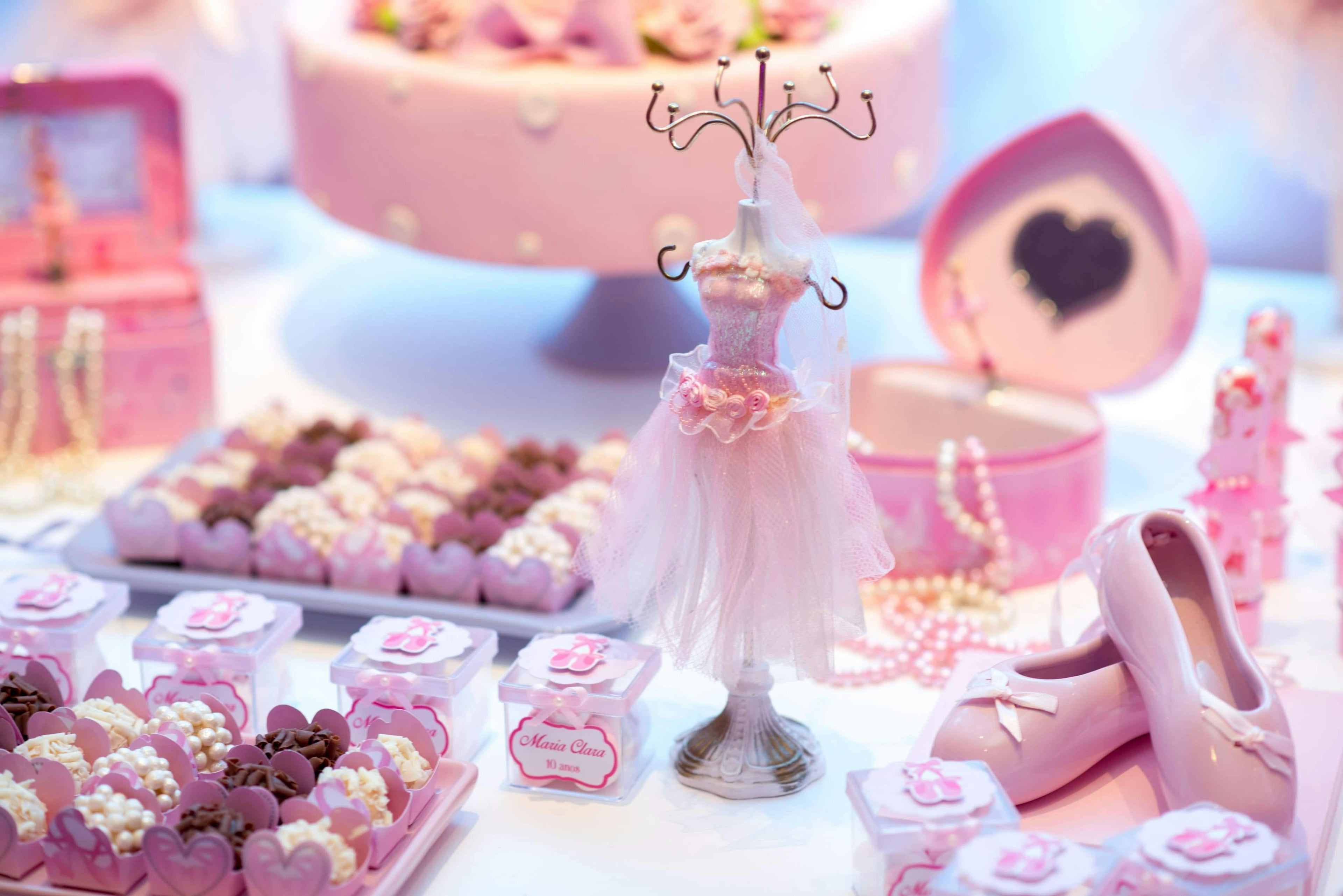 Sweet table with pastries, a cake, and decorative shoes in a pink-themed setting. party food, catering, The Ultimate Royal Spa luxury