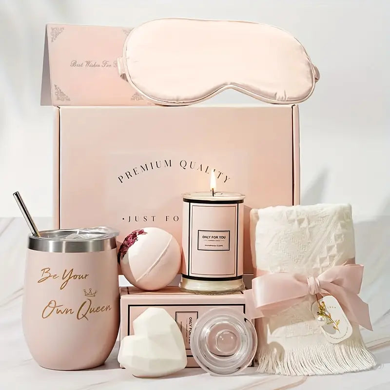 Luxury spa Pink gift set with a sleep mask, cup, candle, bath bomb, and towel on a white background.